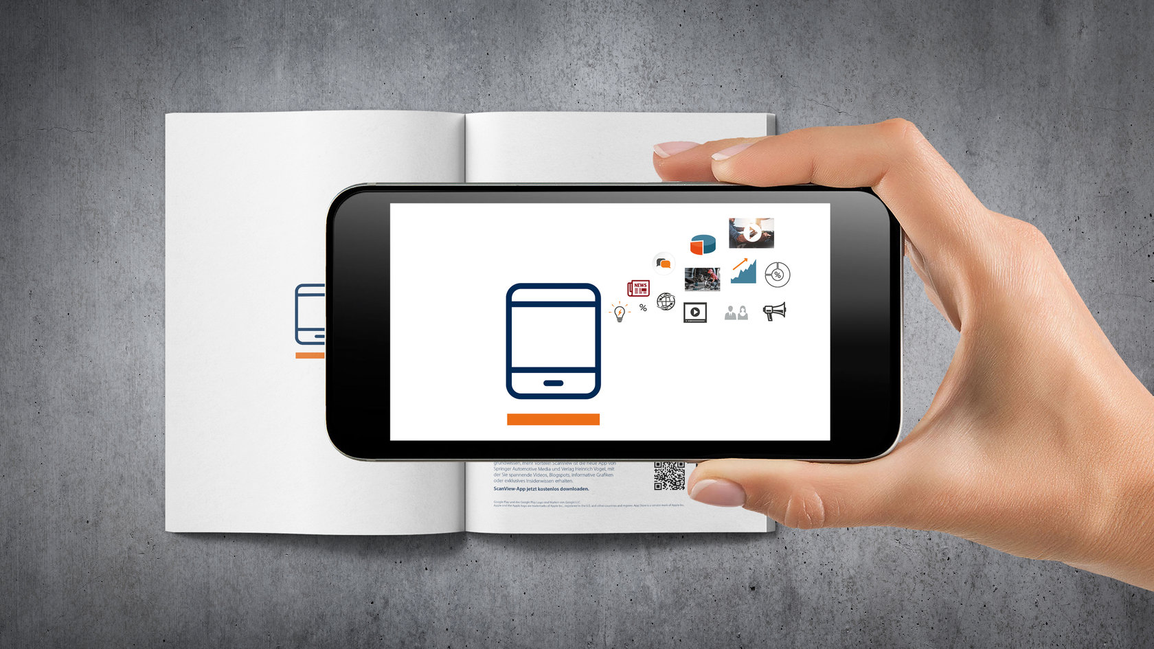 [Translate to EN:] Augmented Reality App auf Handy vor Magazin